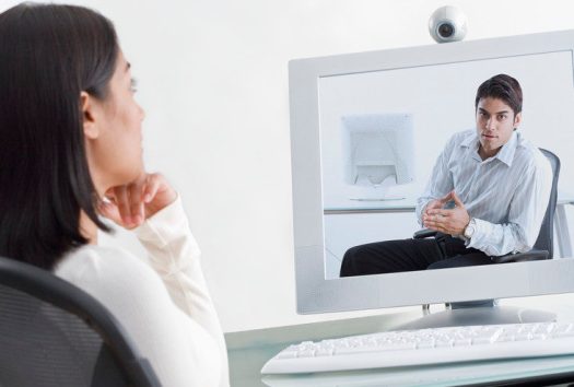 Businesswoman on Videoconference with Businessman